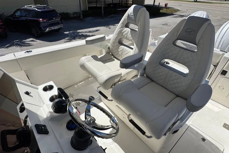  Yacht Photos Pics 2026 Sailfish 272 CC boat cockpit with luxurious seating and modern steering wheel.