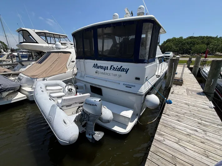  Yacht Photos Pics 1993 Carver 440 Aft Cabin Motor Yacht docked with inflatable boat and Honda motor.