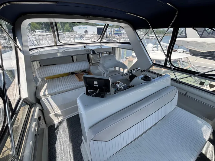  Yacht Photos Pics 1993 Carver 440 Aft Cabin Motor Yacht interior with helm and seating area.