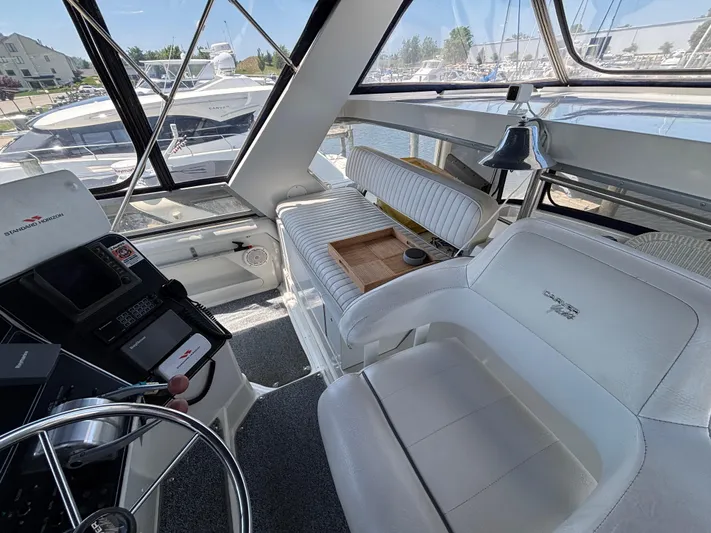  Yacht Photos Pics 1993 Carver 440 Aft Cabin Motor Yacht interior with helm and seating area.