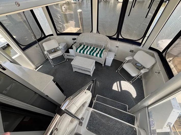  Yacht Photos Pics 1993 Carver 440 Aft Cabin Motor Yacht interior with seating and carpeted flooring.