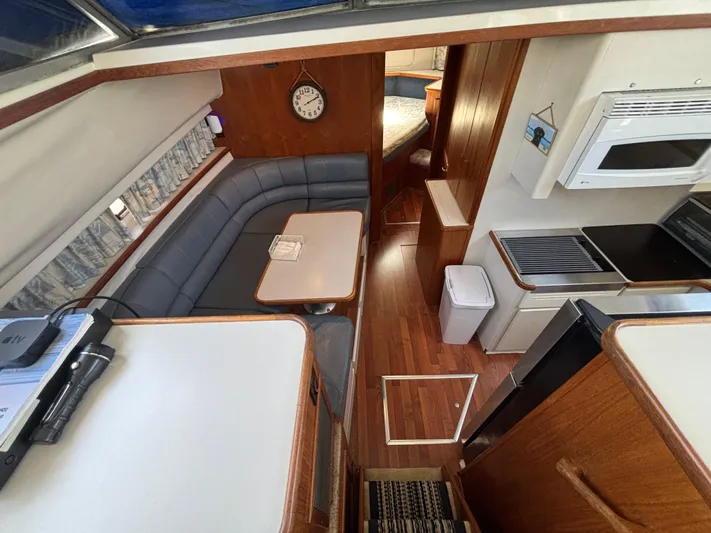  Yacht Photos Pics 1993 Carver 440 Aft Cabin Motor Yacht interior with dining area and kitchen.