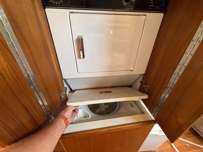  Yacht Photos Pics 1993 Carver 440 Aft Cabin Motor Yacht laundry area with wooden cabinetry.