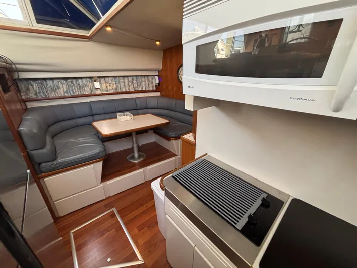  Yacht Photos Pics 1993 Carver 440 Aft Cabin Motor Yacht interior with dining area and kitchen amenities.