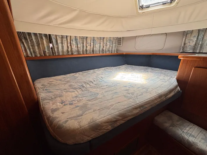  Yacht Photos Pics 1993 Carver 440 Aft Cabin Motor Yacht bedroom with large bed and wooden accents.