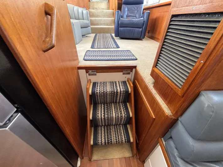  Yacht Photos Pics Interior of 1993 Carver 440 Aft Cabin Motor Yacht with carpeted stairs and seating.