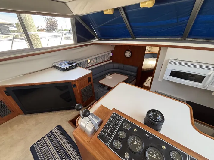  Yacht Photos Pics Interior of 1993 Carver 440 Aft Cabin Motor Yacht with helm, seating, and kitchen area.