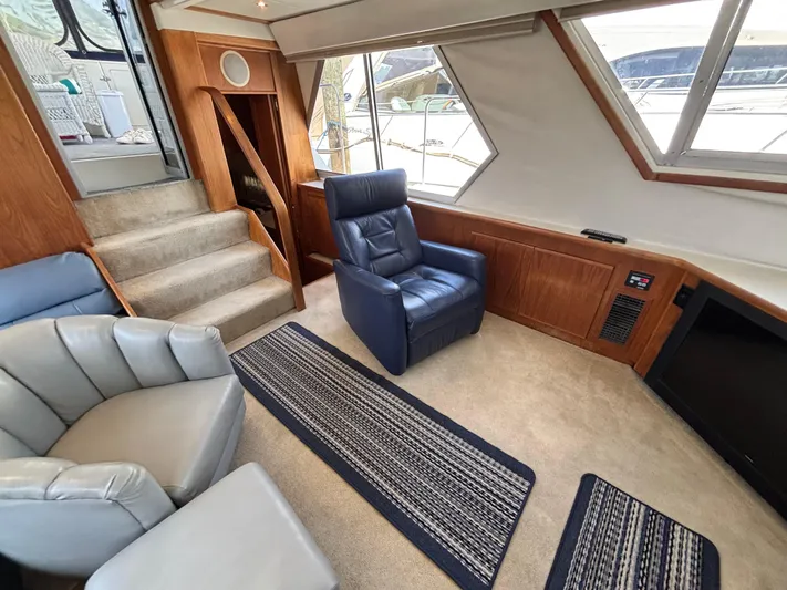  Yacht Photos Pics Interior of 1993 Carver 440 Aft Cabin Motor Yacht with plush seating and carpeted flooring.