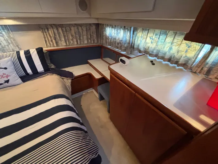  Yacht Photos Pics Cozy cabin interior of 1993 Carver 440 Aft Cabin Motor Yacht with striped bedding.