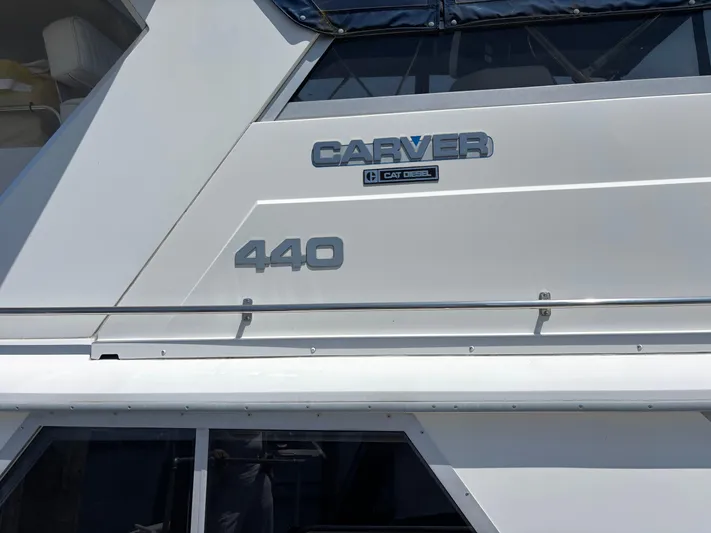  Yacht Photos Pics 1993 Carver 440 Aft Cabin Motor Yacht, side view with logo and model details.