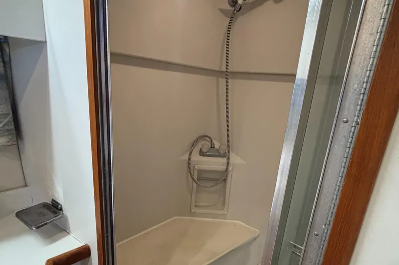  Yacht Photos Pics Shower area in 1993 Carver 440 Aft Cabin Motor Yacht, featuring compact design and handheld showerhead.