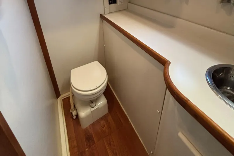  Yacht Photos Pics Bathroom interior of 1993 Carver 440 Aft Cabin Motor Yacht with toilet and sink.
