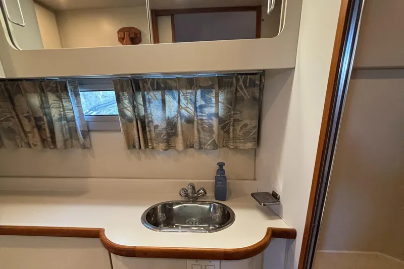  Yacht Photos Pics Interior of 1993 Carver 440 Aft Cabin Motor Yacht bathroom with sink and window.