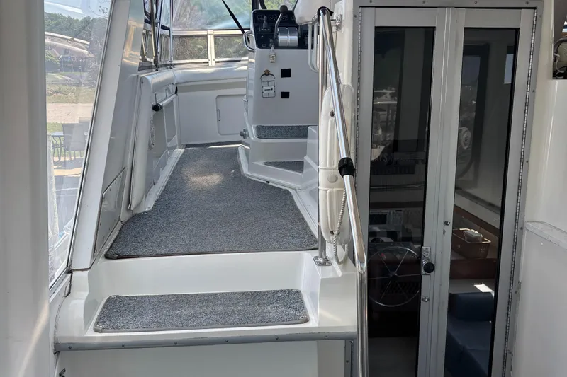  Yacht Photos Pics 1993 Carver 440 Aft Cabin Motor Yacht interior with carpeted steps and glass door.