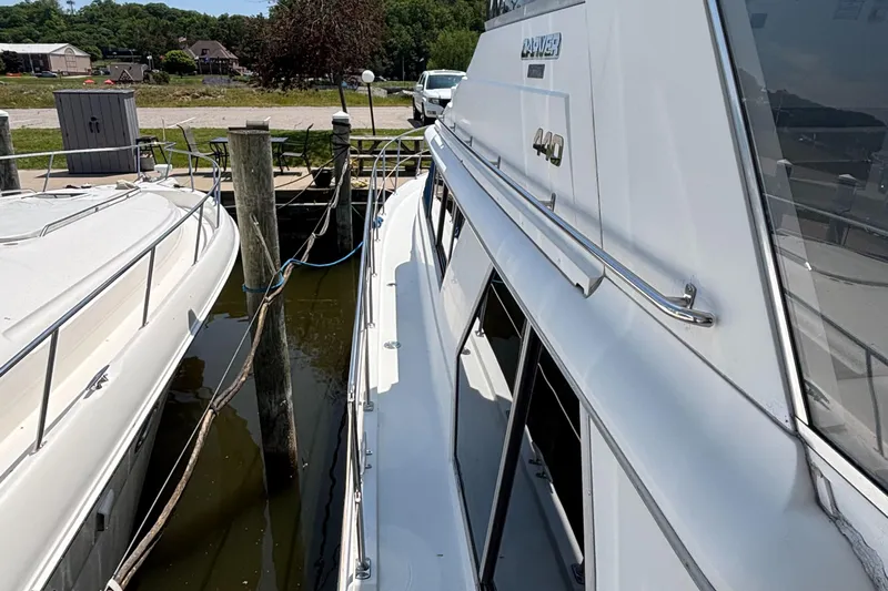  Yacht Photos Pics 1993 Carver 440 Aft Cabin Motor Yacht docked at marina, side view.