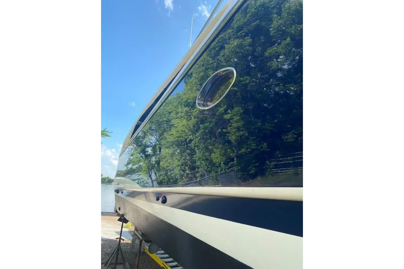  Yacht Photos Pics Side view of a 1998 Sunseeker Predator 58 yacht reflecting trees and sky.