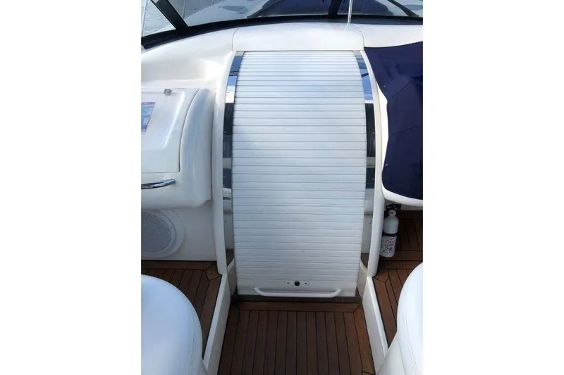  Yacht Photos Pics 1998 Sunseeker Predator 58 yacht interior with sleek white paneling and wood flooring.