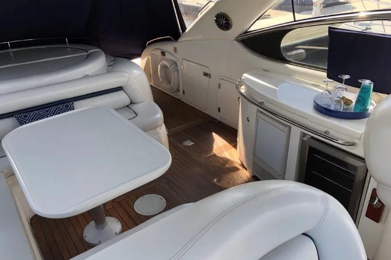  Yacht Photos Pics Luxurious interior of a 1998 Sunseeker Predator 58 yacht with elegant seating and table.