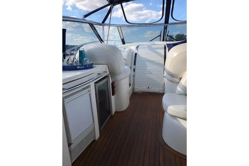  Yacht Photos Pics Interior of 1998 Sunseeker Predator 58 yacht with white seating and wooden flooring.