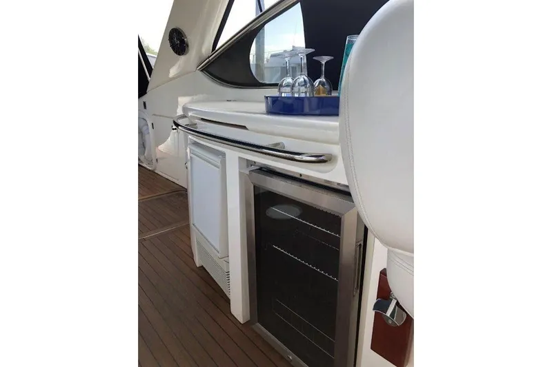  Yacht Photos Pics Interior of 1998 Sunseeker Predator 58 yacht with bar area and glassware.
