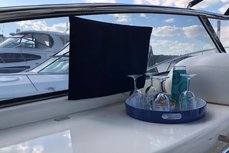  Yacht Photos Pics Interior of 1998 Sunseeker Predator 58 yacht with tray of glasses and scenic view.