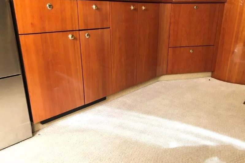  Yacht Photos Pics Interior of 1998 Sunseeker Predator 58 yacht with wooden cabinets and beige carpet.