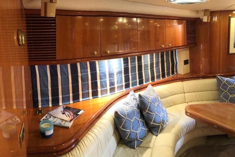  Yacht Photos Pics Interior of 1998 Sunseeker Predator 58 yacht with elegant wood finish and plush seating.