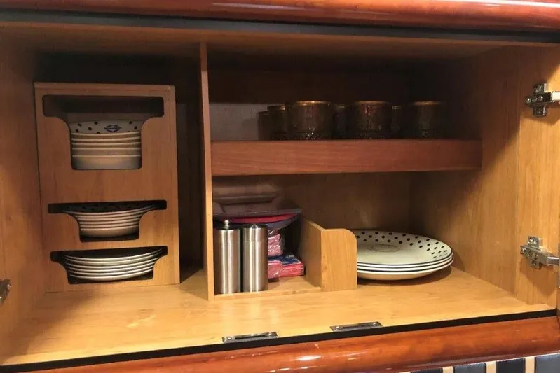  Yacht Photos Pics Cabinet interior on 1998 Sunseeker Predator 58 yacht, featuring organized dishes and cups.