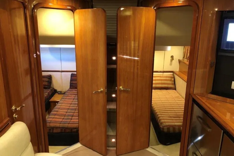  Yacht Photos Pics Interior of 1998 Sunseeker Predator 58 yacht with twin beds and wooden finishes.