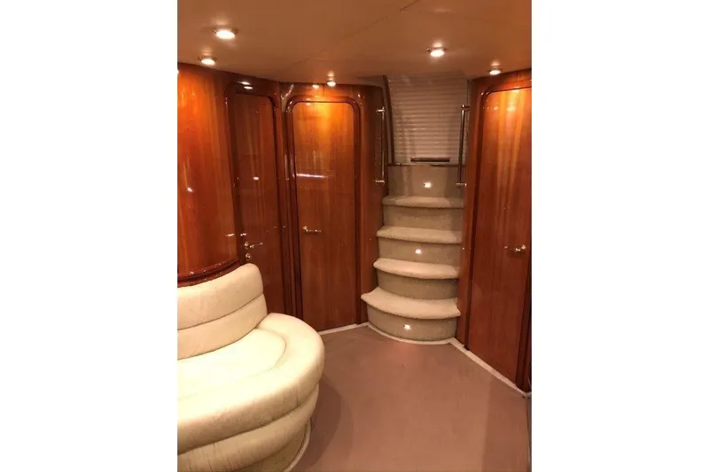  Yacht Photos Pics Luxurious interior of 1998 Sunseeker Predator 58 yacht with elegant wood paneling and plush seating.