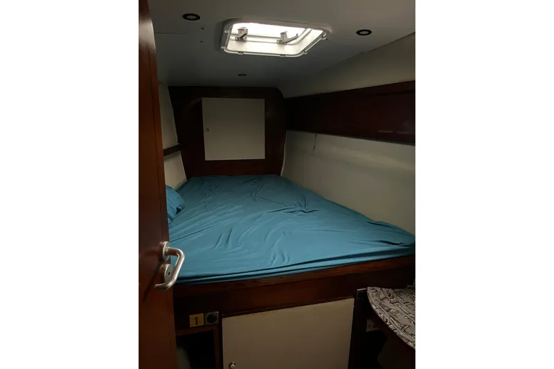 Nikita 1 Yacht Photos Pics Cabin interior of 2004 Fountaine Pajot Bahia 46 catamaran with blue bedding.