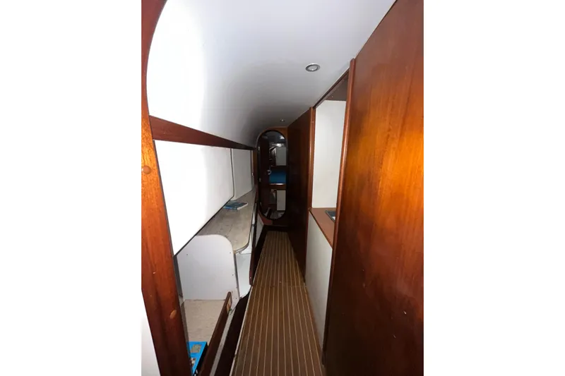 Nikita 1 Yacht Photos Pics Narrow hallway inside 2004 Fountaine Pajot Bahia 46 catamaran with wooden paneling.