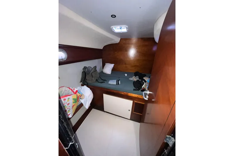 Nikita 1 Yacht Photos Pics 2004 Fountaine Pajot Bahia 46 cabin interior with bed, storage, and porthole.