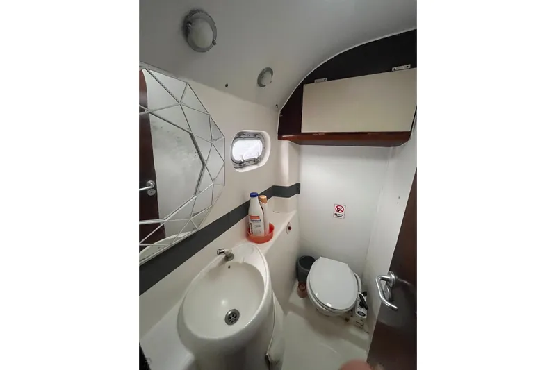 Nikita 1 Yacht Photos Pics Bathroom interior of 2004 Fountaine Pajot Bahia 46 catamaran, featuring sink, toilet, and mirror.