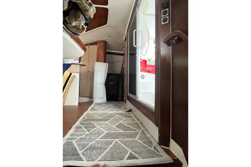 Nikita 1 Yacht Photos Pics Interior view of 2004 Fountaine Pajot Bahia 46 catamaran with modern decor and geometric rug.