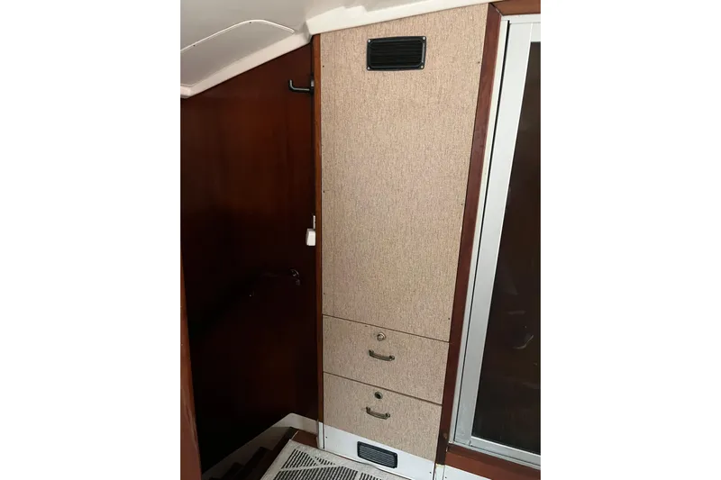 Nikita 1 Yacht Photos Pics Interior view of 2004 Fountaine Pajot Bahia 46 yacht, featuring wooden cabinetry and storage drawers.