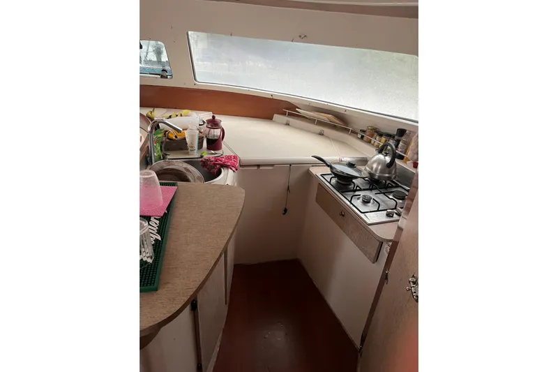 Nikita 1 Yacht Photos Pics Interior view of 2004 Fountaine Pajot Bahia 46 catamaran kitchen with stove and sink.