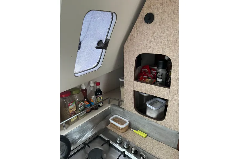 Nikita 1 Yacht Photos Pics Galley of 2004 Fountaine Pajot Bahia 46 with spices and condiments near window.