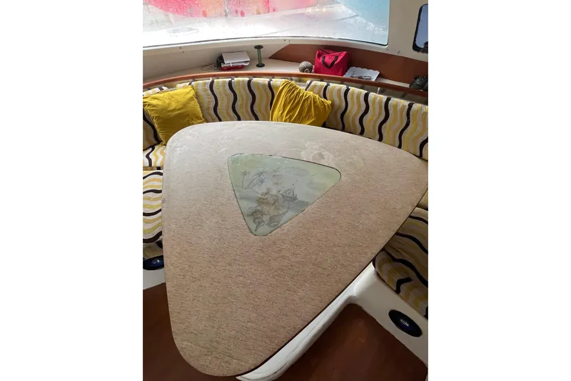 Nikita 1 Yacht Photos Pics Interior of 2004 Fountaine Pajot Bahia 46 with stylish seating and decorative table.