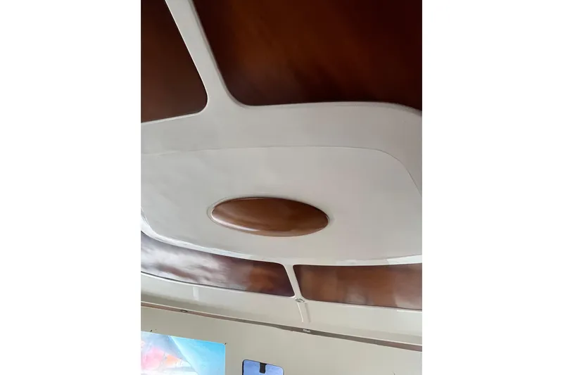 Nikita 1 Yacht Photos Pics Interior ceiling of 2004 Fountaine Pajot Bahia 46 catamaran, featuring wood and white accents.