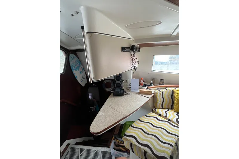 Nikita 1 Yacht Photos Pics Interior of 2004 Fountaine Pajot Bahia 46 catamaran with cozy seating and navigation equipment.