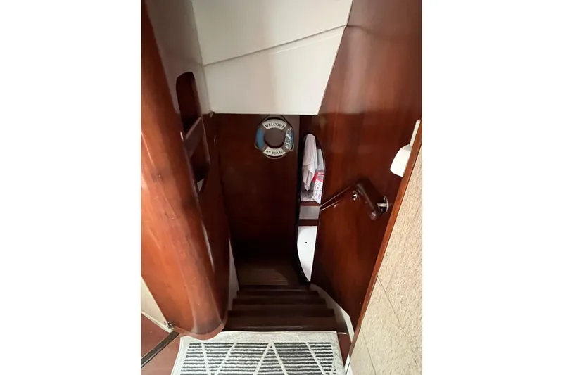 Nikita 1 Yacht Photos Pics Staircase inside 2004 Fountaine Pajot Bahia 46 yacht with wooden paneling and nautical decor.