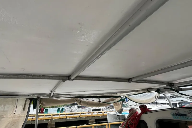 Nikita 1 Yacht Photos Pics 2004 Fountaine Pajot Bahia 46 catamaran canopy with marina view in background.