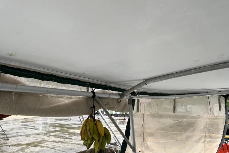 Nikita 1 Yacht Photos Pics Interior view of 2004 Fountaine Pajot Bahia 46 catamaran with bananas hanging.