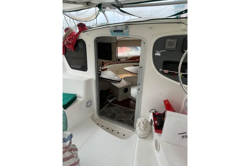 Nikita 1 Yacht Photos Pics Interior view of 2004 Fountaine Pajot Bahia 46 catamaran, showcasing cockpit and cabin entrance.