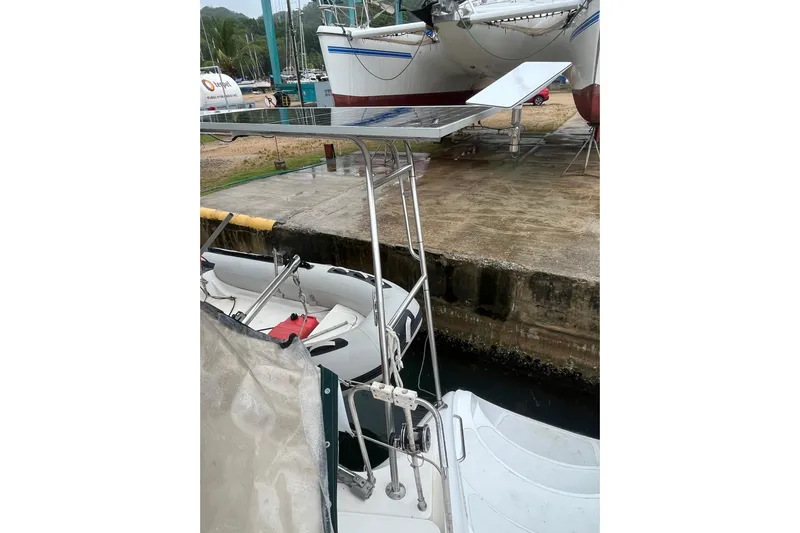 Nikita 1 Yacht Photos Pics 2004 Fountaine Pajot Bahia 46 catamaran with solar panels at a marina dock.