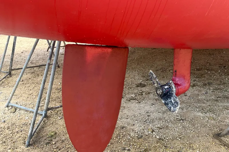 Nikita 1 Yacht Photos Pics Red hull and propeller of 2004 Fountaine Pajot Bahia 46 catamaran on dry dock.