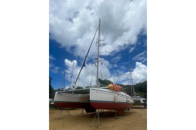 Nikita 1 Yacht Photos Pics 2004 Fountaine Pajot Bahia 46 catamaran on land under a cloudy sky.