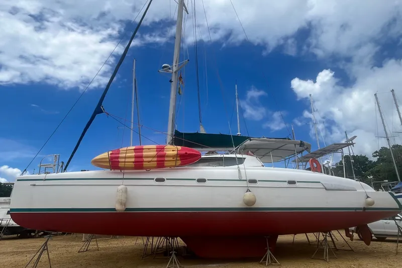 Nikita 1 Yacht Photos Pics 2004 Fountaine Pajot Bahia 46 catamaran on land, with a vibrant sky backdrop.