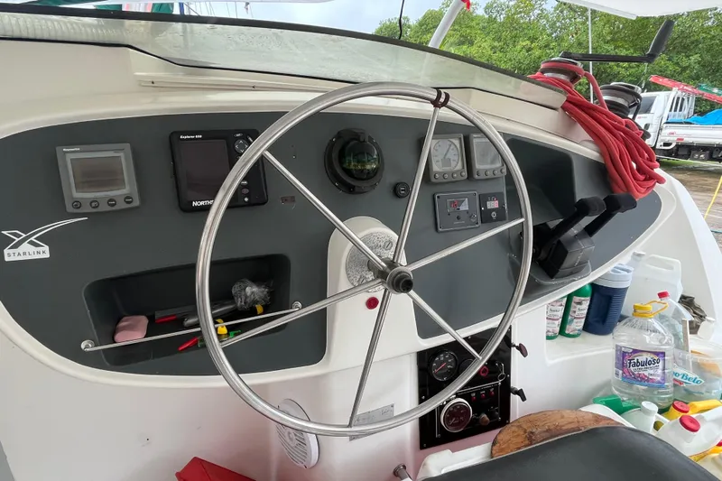 Nikita 1 Yacht Photos Pics Helm of 2004 Fountaine Pajot Bahia 46 catamaran with navigation instruments and steering wheel.